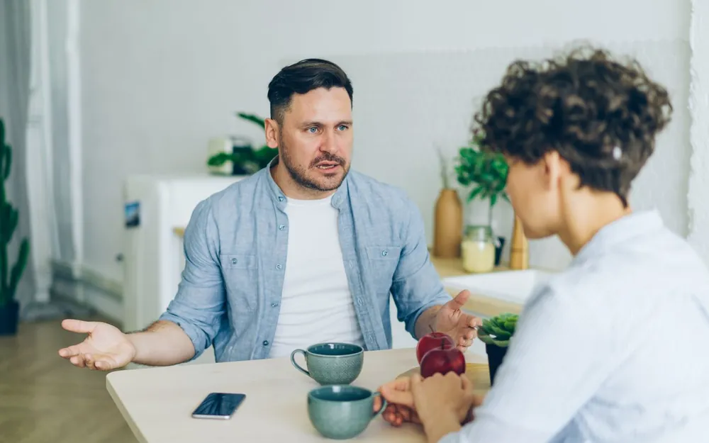 Two adults discussing next steps at a table